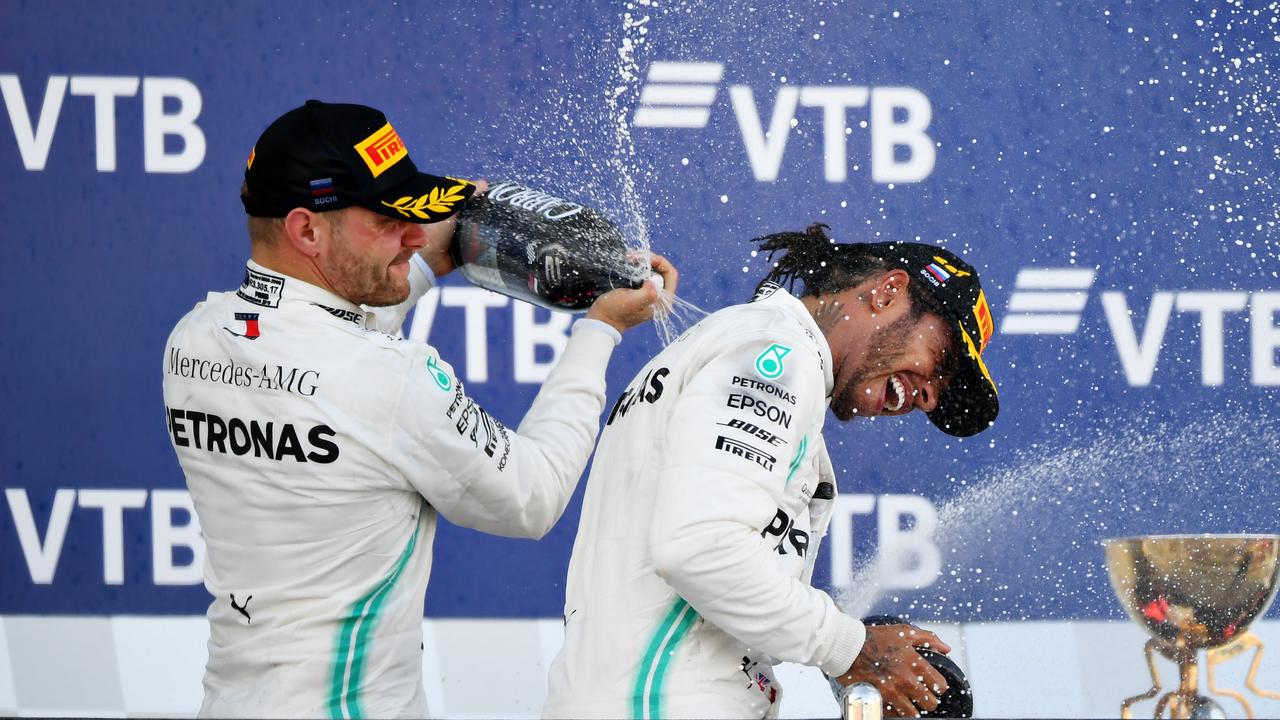 Lewis Hamilton and Valtteri Bottas celebrate on the podium. Picture: Clive Mason