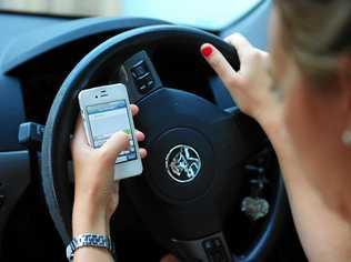 DISTRACTION: Using your mobile phone while driving can bring costly consequences. Picture: Tom Huntley GLADV061212PHON