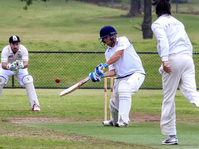 Long Island skipper Aaron Paxton goes on the attack against Crib Point opening bowler Glenn Barclay as keeper Callan Campbell looks on. Picture: Luis Enrique Ascui