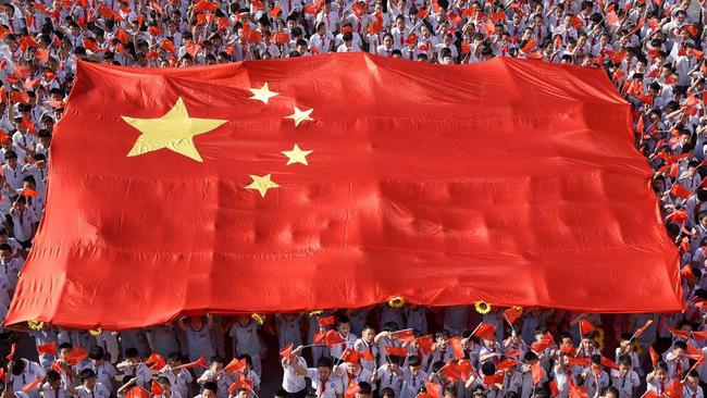 School students hold a giant Chinese flag in Handan, Hebei province, early this month. Picture: China Stringer Network/Reuters