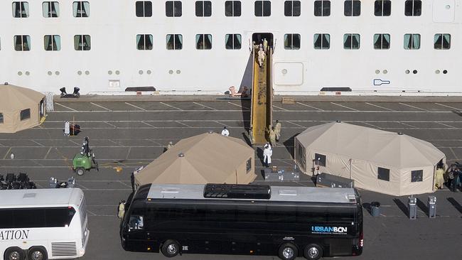 Medical personnel help load passengers on to buses as they are disembarked from the Grand Princess cruise ship at the Port of Oakland in Oakland, California on March 10, 2020. Picture: Josh Edelson / AFP