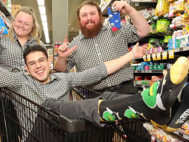 Hollywell Drake's staff wearing socks. They are assistant Manager Nathan Gardner (beard), Laura Parviainen and Ajdin Havic.  When people buy a News Corp AU paper at Drakes on the weekend, they will get a pair of crazy socks. Picture Glenn Hampson