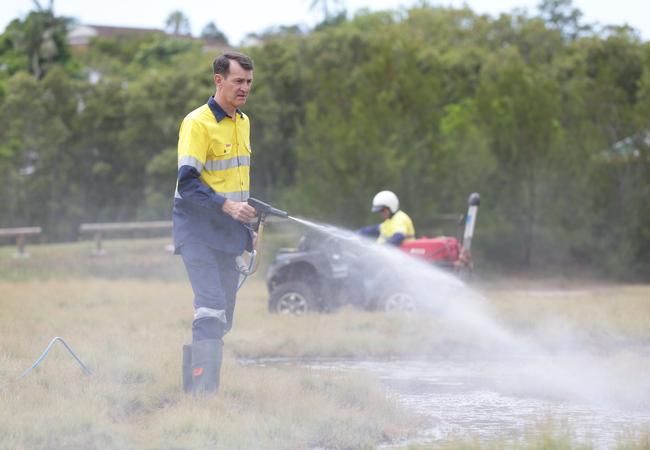 Brisbane Lord Mayor Graham Quirk spraying for mosquitoes in Norman Park. Picture: Peter Wallis