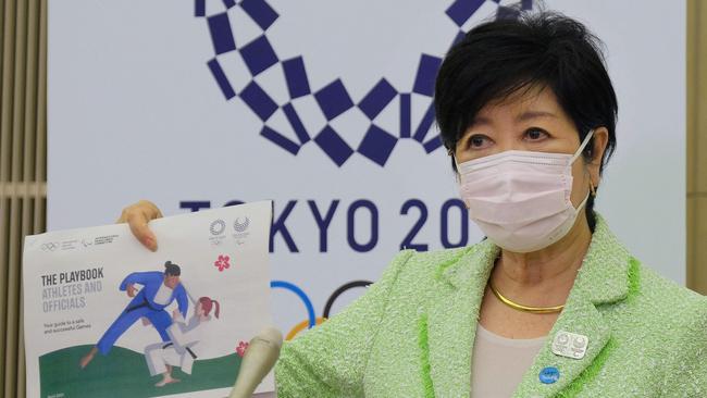 Tokyo Governor Yuriko Koike shows the Tokyo Olympics playbook which details what athletes can and can’t do. Picture: AFP