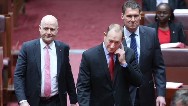 One Nation’s Fraser Anning  is escorted into the chamber by senators Cory Bernardi and David Leyonhjelm today. Picture Gary Ramage