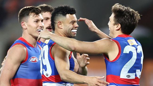 CANBERRA, AUSTRALIA - APRIL 23: Jason Johannisen of the Bulldogs celebrates kicking a goal with team mates during the round six AFL match between the Greater Western Sydney Giants and the Western Bulldogs at Manuka Oval on April 23, 2021 in Canberra, Australia. (Photo by Cameron Spencer/Getty Images)