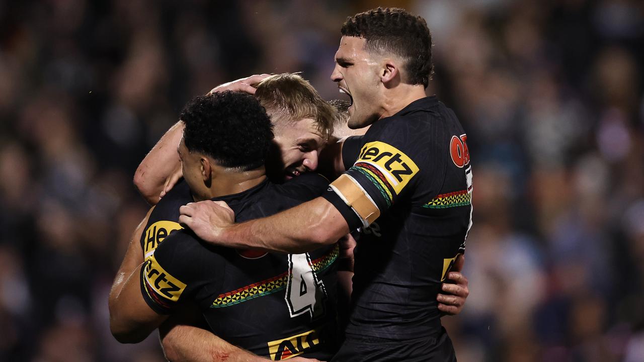 PENRITH, AUSTRALIA - SEPTEMBER 13: Luke Garner of the Panthers celebrates scoring a try with Paul Alamoti and Nathan Cleary of the Panthers during the NRL Qualifying Final match between Penrith Panthers and Sydney Roosters at BlueBet Stadium on September 13, 2024 in Penrith, Australia. (Photo by Cameron Spencer/Getty Images)