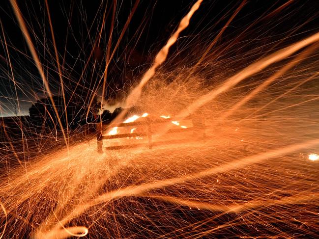 Embers from bushfires are fanned by strong winds in the area around the town of Nowra in the Australian state of New South Wales on December 31, 2019. - Thousands of holidaymakers and locals were forced to flee to beaches in fire-ravaged southeast Australia on December 31, as blazes ripped through popular tourist areas leaving no escape by land. Picture: Saeed Khan/AFP