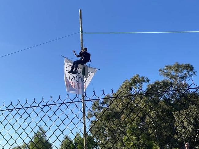 A Blockade Australia activist clinking to a mono pole blocking all lanes to the Port of Brisbane. Picture: Supplied