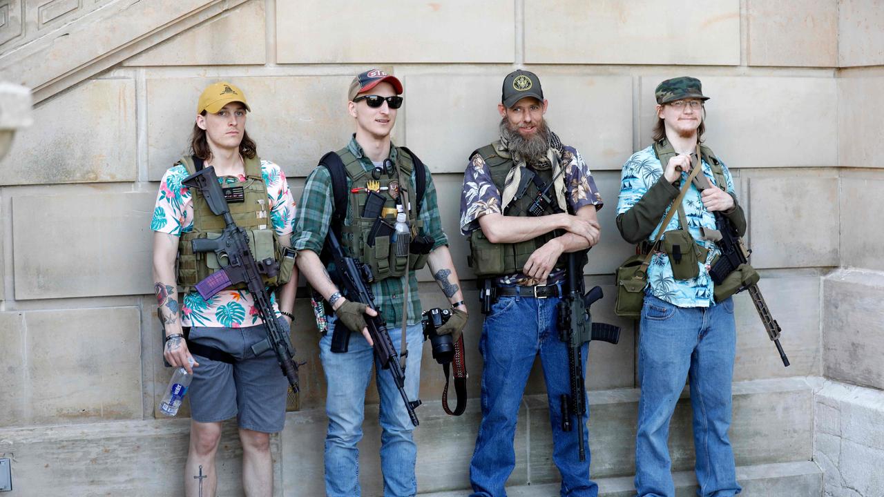 Armed protesters demonstrate during the Michigan Conservative Coalition-organised ‘Operation Haircut’ in May this year, protesing Michigan Governor Gretchen Whitmer’s mandatory closure to curtail the coronavirus pandemic. Picture: AFP