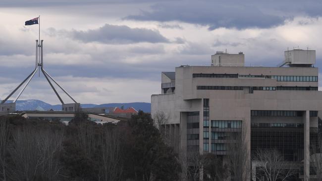 Parliament House is seen next to the High Court building on the shore of Lake Burley Griffin in Canberra.