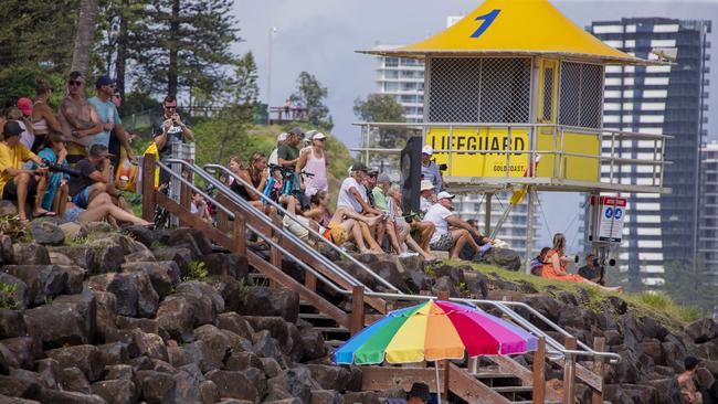 A crowd watches on as surfers enjoy the large swell at Snapper Rocks on Sunday 2 January 2022. Picture: Jerad Williams