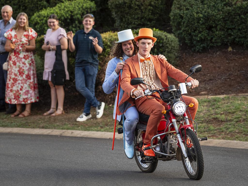 Graduate Daniel Sheath (back) and partner Matthew Thom arrive as Dumb and Dumber characters on a postie bike at Mary MacKillop Catholic College formal at Highfields Cultural Centre, Thursday, November 14, 2024. Picture: Kevin Farmer