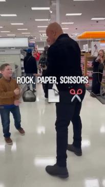 Kid takes on the Rock at a game of scissors, paper, rock