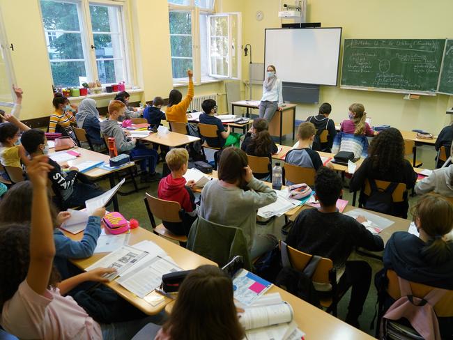 Teacher Julia Rakow wears a protective face mask as she leads a class in the origins of German poetry at Sophie-Charlotte Gymnasium high school during the coronavirus pandemic in Berlin, Germany. Picture: Getty