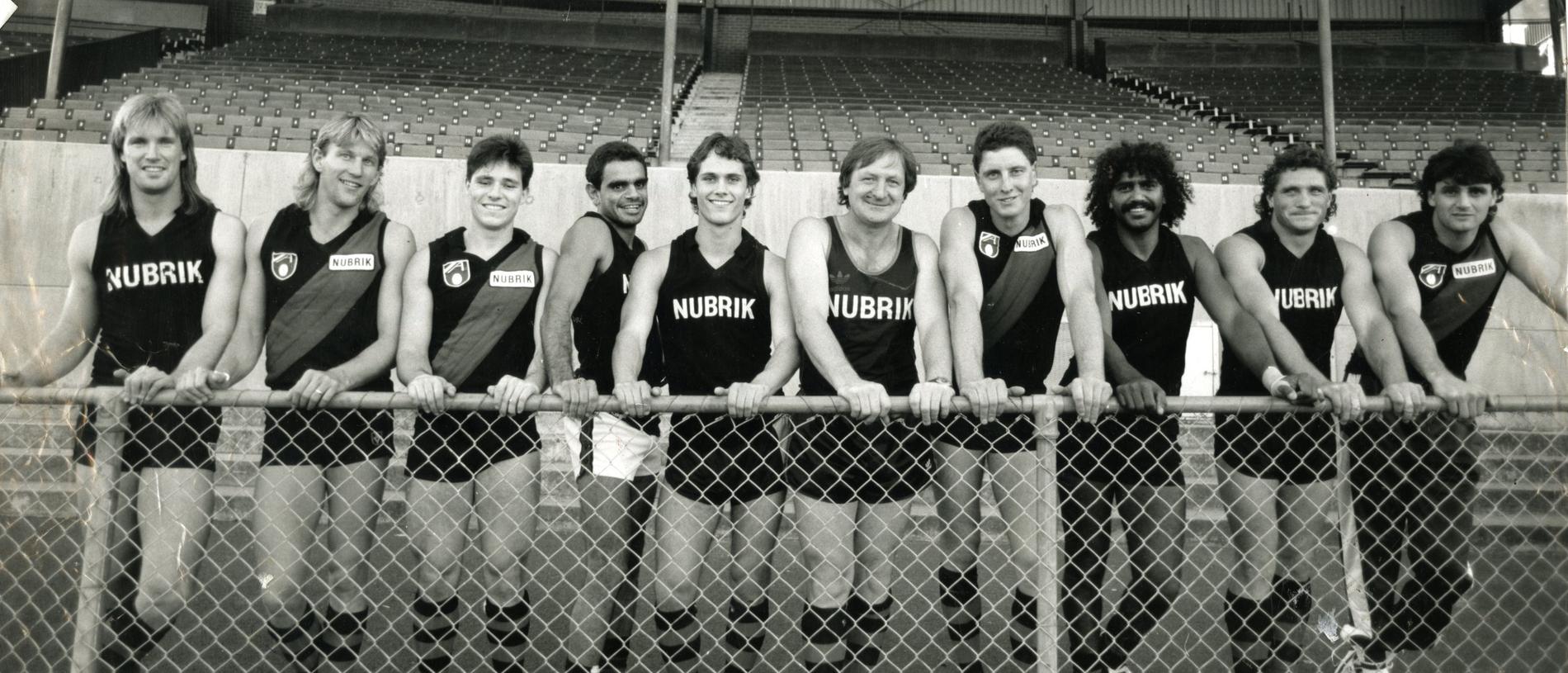 Essendon’s South Australian contingent in 1991 of Greg Anderson, Kieran Sporn, Shane Radbone, Michael Long, Gavin Wanganeen, Michael Werner, Derek Kickett, David Robertson, Alan Schwartz, with Bombers coach Kevin Sheedy in the centre. Picture: Ray Titus