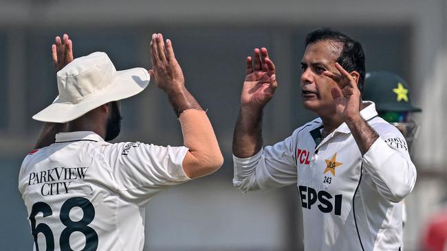 Pakistan's Noman Ali (right) guided Pakistan to a breakthrough win. (Photo by Farooq NAEEM / AFP)