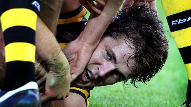 Tough as nails from the start. Luke Hodge at the bottom of a pack against Richmond, the team he made his debut against back in 2002.