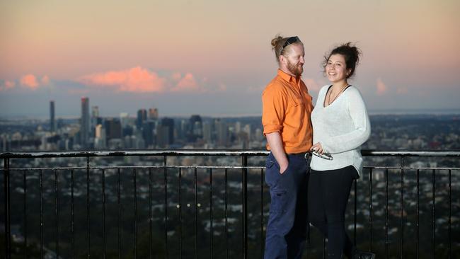 David Tompkins and Denisse Ramos enjoy sunset at Mt Coot-tha. Picture: Tara Croser