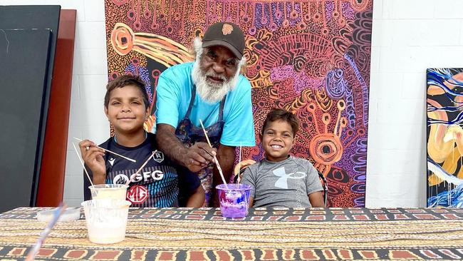 Artist Paul Andy and family at APY Adelaide Studio. There is no suggestion any of the art in this photo was interfered with. Picture: APY Art Centre Collective