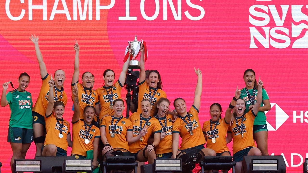 Australia's players celebrate with their trophy after winning the HSBC World Rugby Sevens women's final match between Australia and France at the Metropolitano stadium in Madrid. (Photo by OSCAR DEL POZO / AFP)