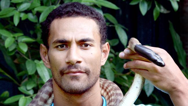 Gold Coast Blaze player Mika Vukona comes face to face with a black headed python at Currumbin Wildlife Sanctuary.