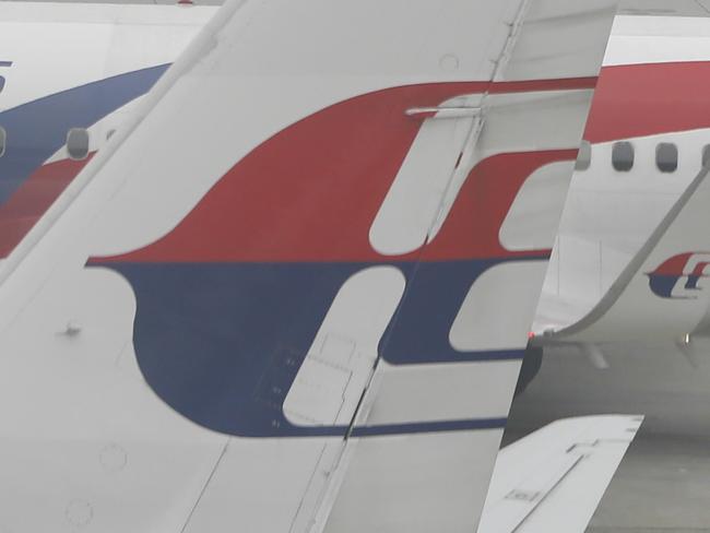 A fleet of Malaysia Airlines planes shrouded with haze are seen taxied on the tarmac of Kuala Lumpur International Airport in Sepang, Malaysia on Wednesday, Sept. 30, 2015. Wildfires caused by illegal land clearing in Indonesia's Sumatra and Borneo islands often spread choking haze to neighboring countries such as Malaysia and Singapore. (AP Photo/Joshua Paul)