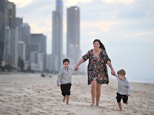 4/7/2024: Dani Kaye with her kids, Charlie Hooper 5 (dark hair) and Zac Hooper 4 on the Broadbeach sand,  Gold Coast. The Queensland coast and how dreams of a coastal lifestyle are being overwhelmed by overdevelopment.  pic: Lyndon Mechielsen / The Australian