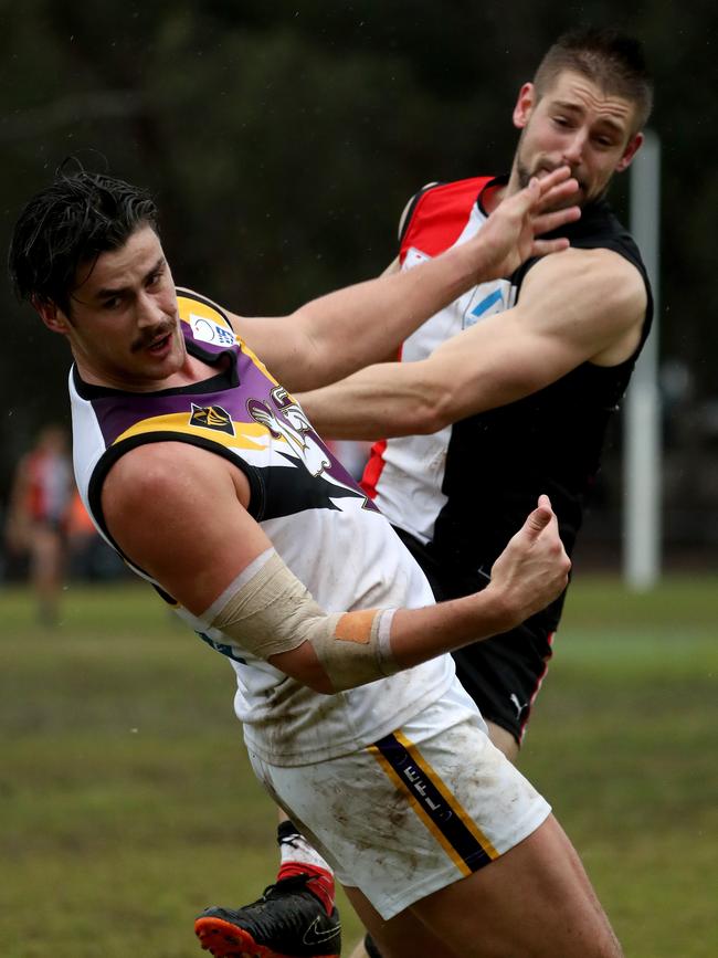 Tom Boyd competes with a North Ringwood defender in a marking contest.