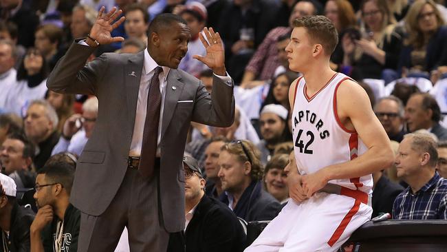 Head coach Dwane Casey of the Toronto Raptors talks to Jakob Poeltl #42.