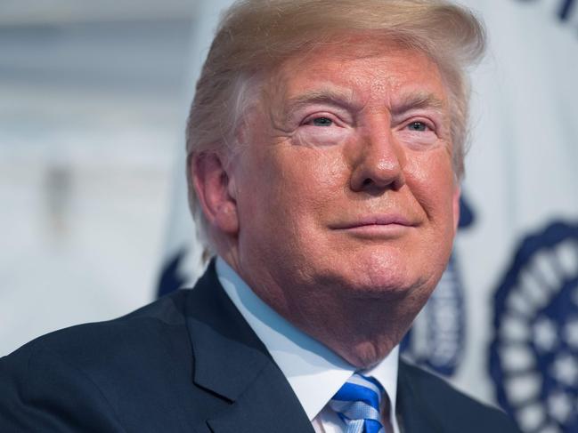 US President Donald Trump looks on during a Change of Command ceremony as Admiral Karl Schultz takes over from Admiral Paul Zukunft as the Commandant of the US Coast Guard at US Coast Guard Headquarters in Washington, DC, June 1, 2018. / AFP PHOTO / SAUL LOEB
