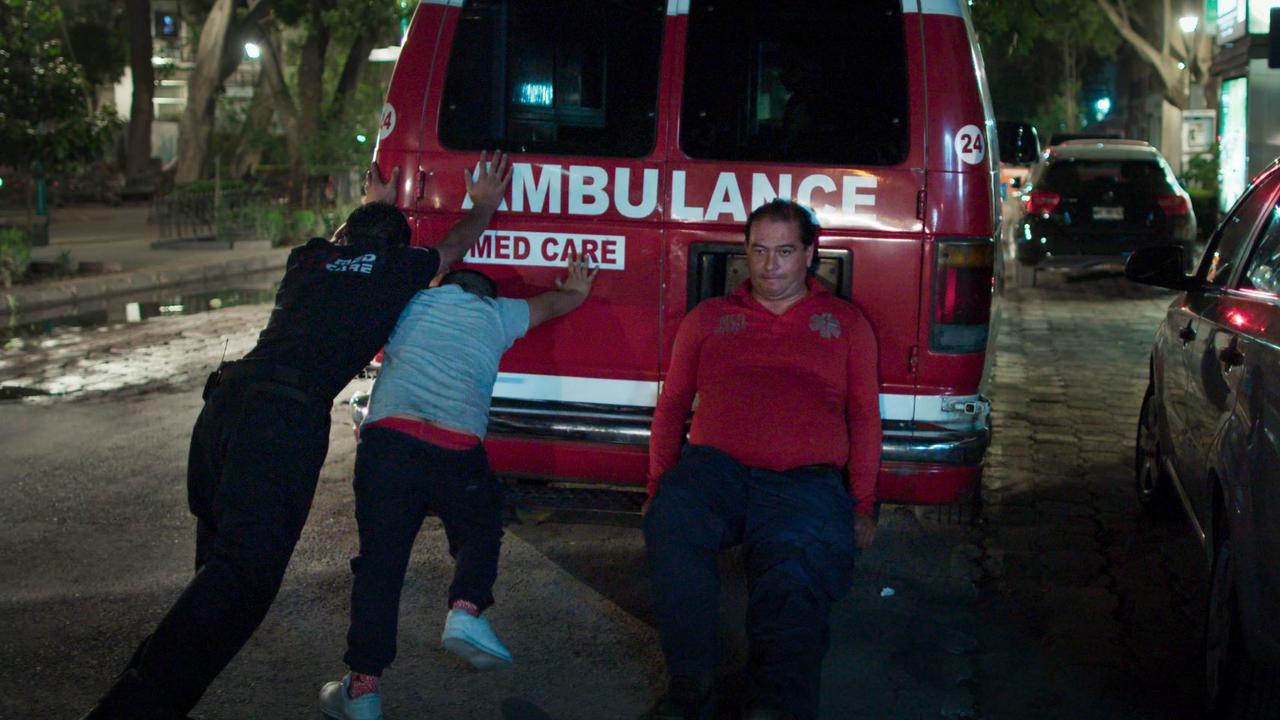 Father and sons give their ambulance a push on another nighttime run.