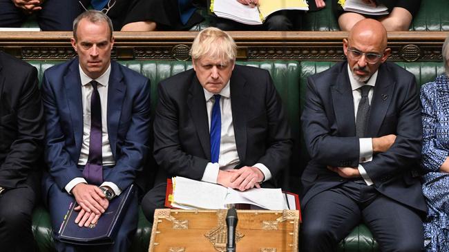 Johnson flanked by Britain's Justice Secretary and deputy Prime Minister Dominic Raab (L) and Britain's new Chancellor of the Exchequer Nadhim Zahawi (R).