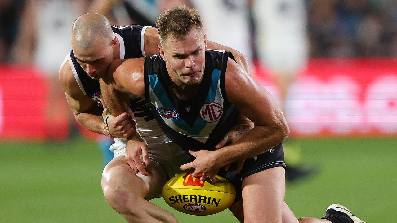 ADELAIDE, AUSTRALIA - MAY 30: Dan Houston of the Power is tackled by Alex Cincotta of the Blues during the 2024 AFL Round 12 match between the Port Adelaide Power and the Carlton Blues at Adelaide Oval on May 30, 2024 in Adelaide, Australia. (Photo by Sarah Reed/AFL Photos via Getty Images)