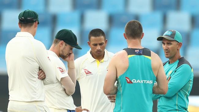 : Justin Langer, coach of Australia, speaks with Travis Head, Matt Renshaw, Shaun Marsh and Usman Khawaja of Australia in Dubai. Picture: Getty Images