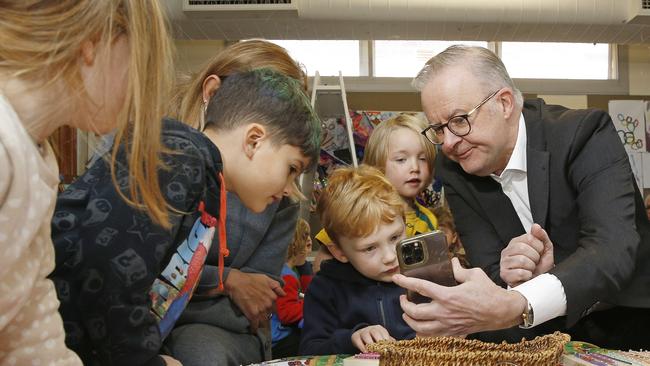 SYDNEY, AUSTRALIA - NewsWire Photos AUGUST 8, 2024: L to R: Olivia Downey-Edmunds -5, Noah Alameddine - 4, , Ned Walker -5 and Walter Boehm -4 as Prime Minister Anthony Albanese shows them a picture of his son and dog. Prime Minister, Anthony Albanese, with Minister for Education, Jason Clare, and the Minister for Early Childhood Education and Youth, Dr Anne Aly at the is in Sydney today with the Minister for Education, Jason Clare, and the Minister for Early Childhood Education and Youth, Dr Anne Aly at the Styles Street Children's Community Long Day Care Centre in Leichhardt. The Government announced a 15% pay rise for Early Childhood Educators. Picture: NewsWire / John Appleyard