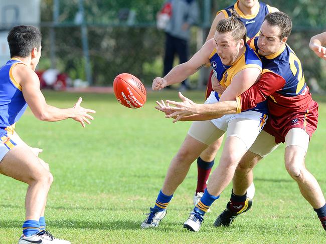 VAFA footy: Therry Penola V Williamstown CYMS. (L-R) Williamstown's Yuma Hemphill (revieving handball), Williamstown's Ryan Joy and Therry Penola's Matt Costello. Picture: Josie Hayden