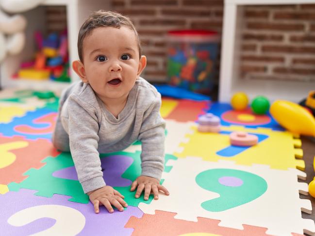 Adorable hispanic baby crawling on floor at kindergarten  Picture: istock