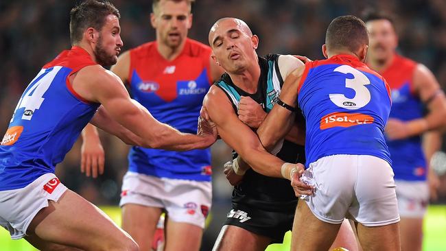 Port Adelaide’s Sam Powell-Pepper stops Melbourne’s Christian Salem.