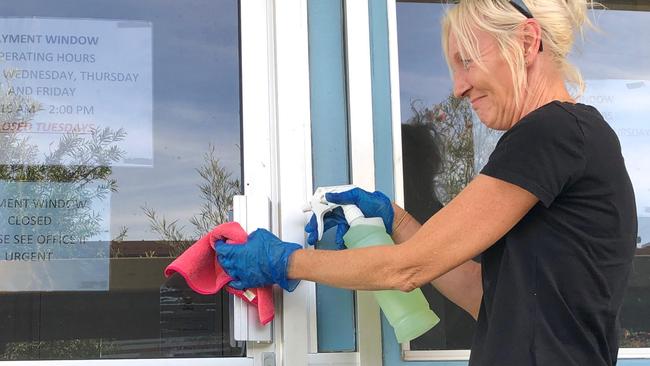 Beenleigh State High School cleaner Mandie Pinnow cleaning ‘high touch’ areas.