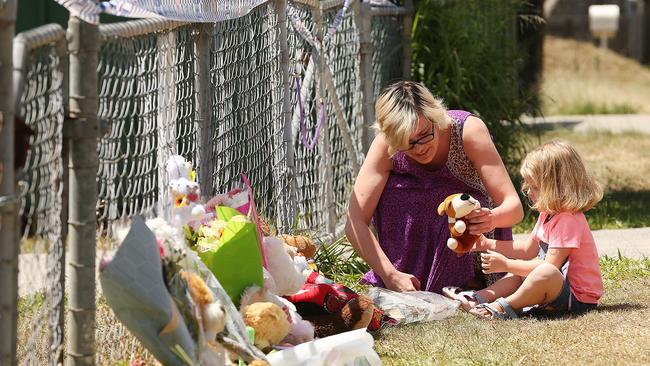 Locals touched by the deaths leave tributes at the front gate at the scene where two toddlers died. Picture: Lyndon Mechielsen