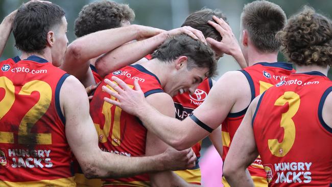 Crow Billy Dowling is surrounded by teammates after kicking a decisive final quarter goal against Sturt. Picture: David Mariuz/SANFL