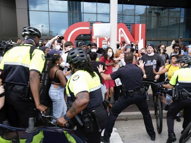 Protesters confront police officers after returning to the area around the CNN centre in Atlanta. Picture: Ben Gray/Atlanta Journal-Constitution via AP