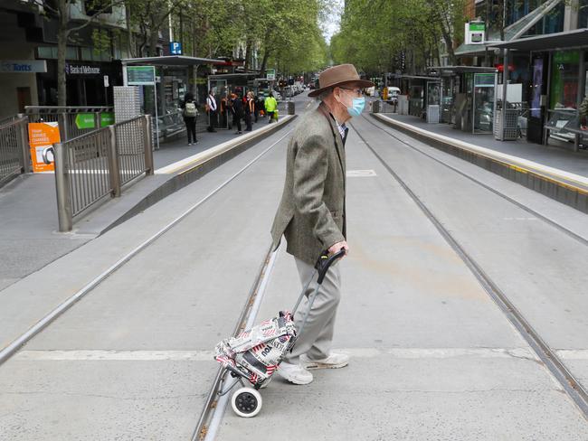 MELBOURNE, AUSTRALIA- NewsWire Photos SEPTEMBER 30, 2020: A man crosses Collins Street in the CBD during COVID-19 lockdown in Melbourne. Picture: NCA NewsWire/ David Crosling