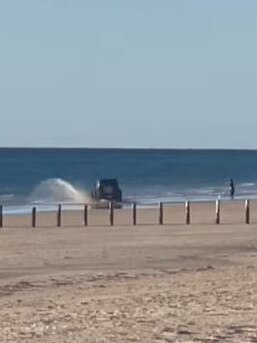 It shows the small 4WD driving in and out of the water before doing doughnuts on the sand. Picture: South Aussie with Cosi