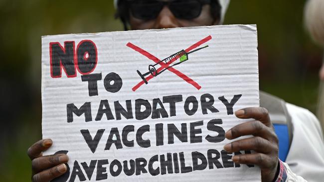 A protester holds up a placard at a demonstration against vaccinations and government restrictions designed to fight the spread of the novel coronavirus in London. Picture: AFP