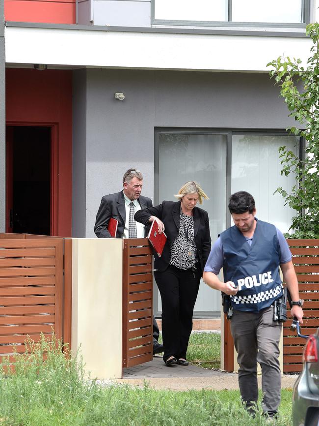 Detectives outside the unit where the shots were fired. Picture: Roger Wyman