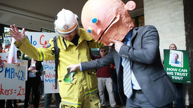 Protesters lampooned Premier Campbell Newman at a rally over pay rises in Brisbane on Monday.