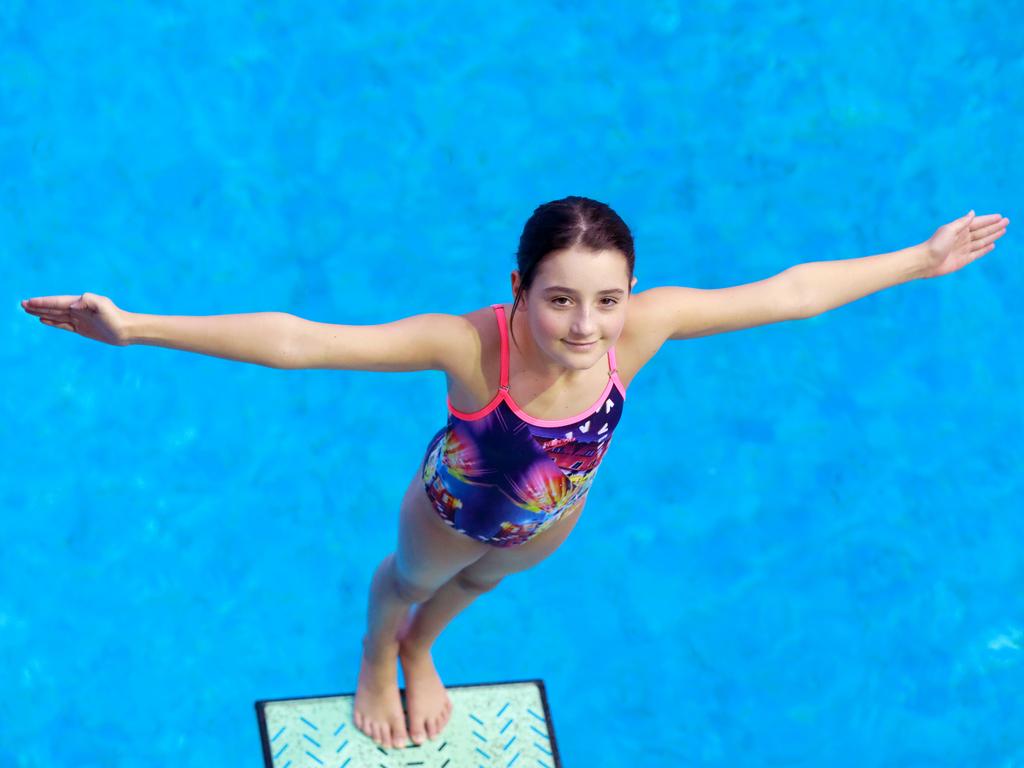 SOUTHERN COURIER/AAP. Champion diver 12 year old Sarah Malcolm pose for photographs at the Aquatic Centre in Sydney Olympic Park. Sydney Olympic Park, Friday 10 May, 2019. Sarah Malcolm was named female diver of the meet at the NSW PSSA diving championships last month, winning two gold in springboard and platform. (AAP IMAGE / Angelo Velardo)