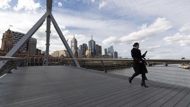 A person crosses the empty Evan Walker Bridge in Melbourne. Picture: Daniel Pockett